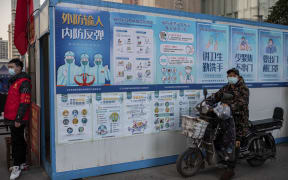 Information posters encouraging people to wash their hands and wear masks, outside a shopping mall in Wuhan. 13, January, 2021.