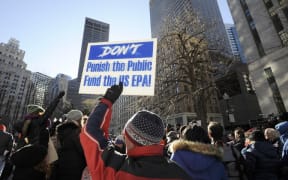 An EPA employee holds a sign during a protest rally by government workers and concerned citizens against the government shutdown on Friday, January 11, 2019 at Post Office Square near the Federal building, headquarters for the EPA and IRS in Boston.AFP