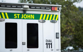 Close up of a St John ambulance on a residential street.