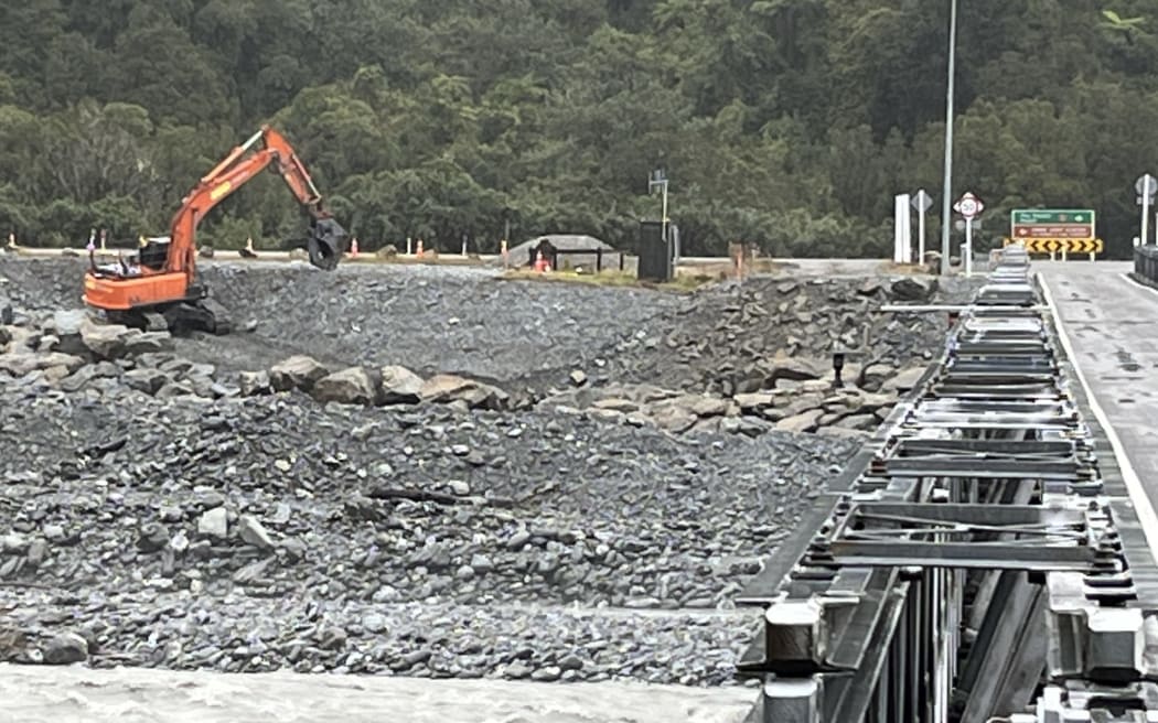 Looking upstream from the Waiho River Bridge, work is underway today on part of the first stage of the project at the Franz Josef Glacier to protect the southern approach to the bridge with new rockfill.