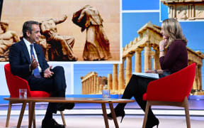 A handout picture released by the BBC, taken and received on November 26, 2023, shows Greece's Prime Minister Kyriakos Mitsotakis appearing on the BBC's "Sunday Morning" political television show in London with journalist Laura Kuenssberg. (Photo by Jeff OVERS / BBC / AFP)