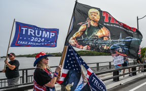 Supporters of former US President Donald Trump gather near his residence at Mar-A-Lago in Palm Beach, Florida, on August 9, 2022. - Former US President Donald Trump said on August 8, 2022, that his Mar-A-Lago residence in Florida was being "raided" by FBI agents in what he called an act of "prosecutorial misconduct." (Photo by Giorgio VIERA / AFP)