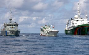 A Palauan law enforcement vessel escorting a Taiwanese long line fishing vessel suspected of illegally shark finning in 2011.