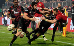 Liam Williams is tackled by Crusaders Matt Todd and Richie Mo'unga.
