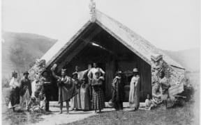An unidentified Maori group in front of the Hinemihi meeting house at Te Wairoa in the 1880s.