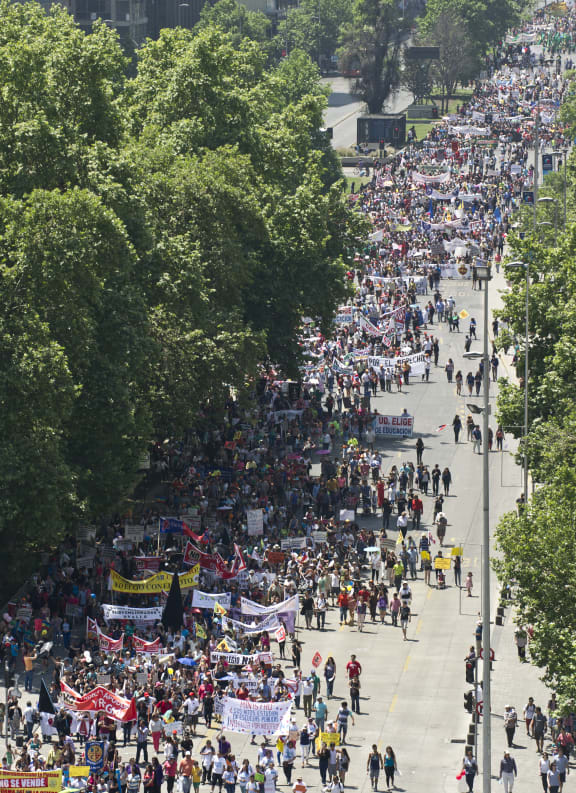 Thousands of Chilean students and their parents march in front of the La Moneda presidential palace in Santiago.