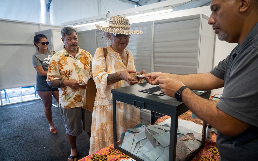 A voter casts her ballot during the first round of the territorial elections in Faa'a, Tahiti, on April 16.