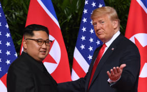 US President Donald Trump gestures as he meets with North Korea's leader Kim Jong Un at the start of their historic US-North Korea summit in 2018.