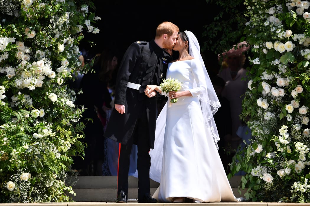 -- AFP PICTURES OF THE YEAR 2018 --

Britain's Prince Harry, Duke of Sussex kisses his wife Meghan, Duchess of Sussex as they leave from the West Door of St George's Chapel, Windsor Castle, in Windsor, on May 19, 2018 after their wedding ceremony. (Photo by Ben STANSALL / POOL / AFP)