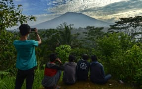 People look at Mount Agung in Karangasem on island of Bali, after warnings a volcanic eruption was imminent.