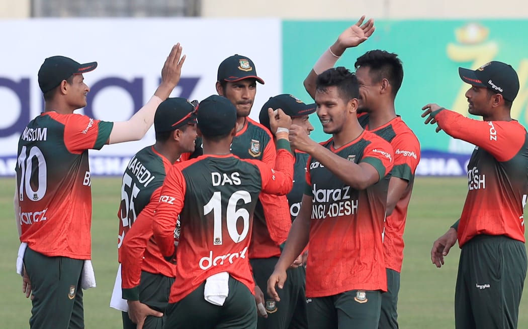 Bangladeshi cricketers celebrate a wicket.