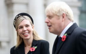 Britain's Prime Minister Boris Johnson (R) and his partner Carrie Symonds attend a Remembrance Sunday ceremony at the Cenotaph on Whitehall in central London.