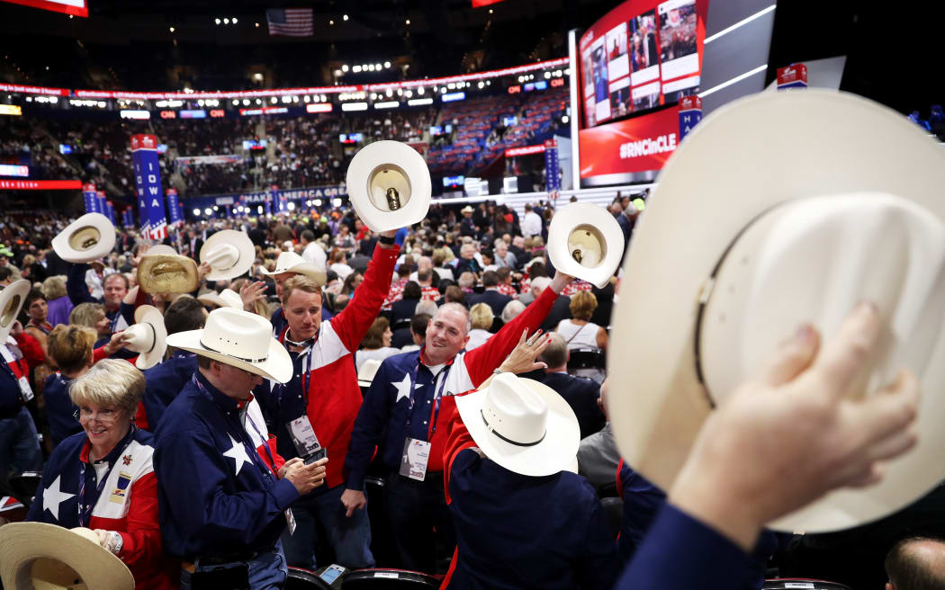 Delegates from Texas wave their hats in the air as the Republican convention begins.