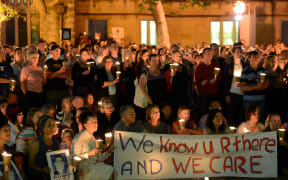 People attend a candlelight vigil in support of asylum seekers, in Sydney on February 23, 2014.