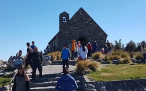 Tourists throng at the church in Tekapo.