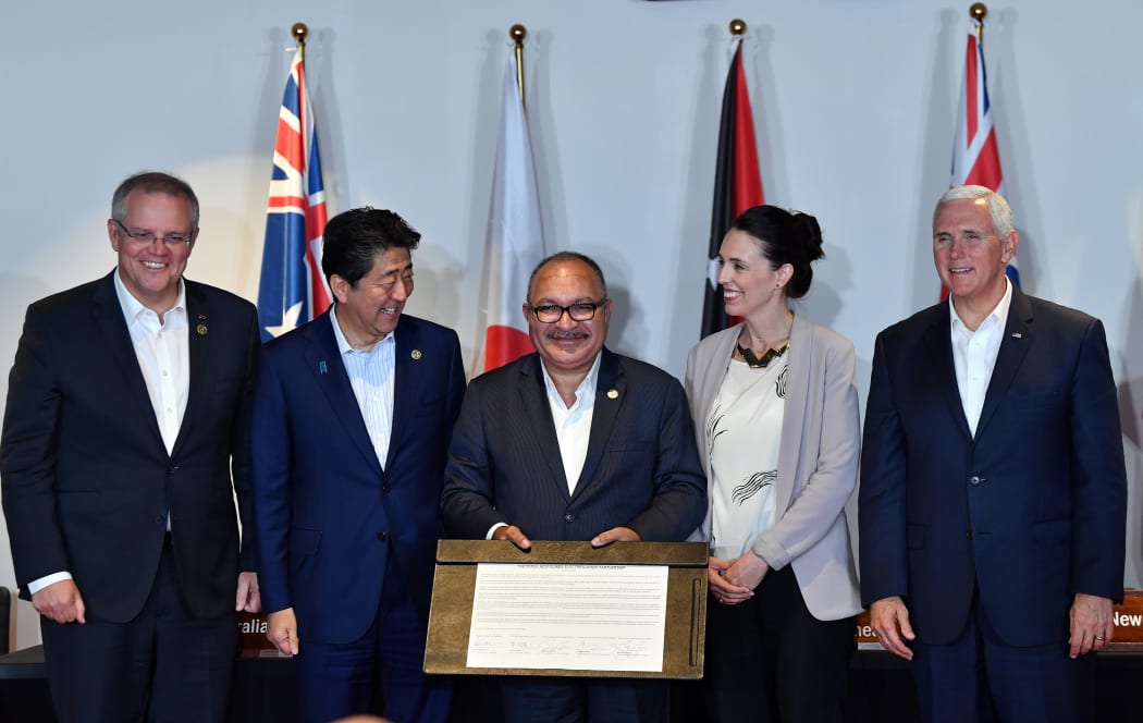 Papua New Guinea's Prime Minister Peter O'Neill displays a document for electricity projects signed by Australia's Prime Minister Scott Morrison, Japan's Prime Minister Shinzo Abe, US Vice President Mike Pence and Prime Minister Jacinda Ardern.