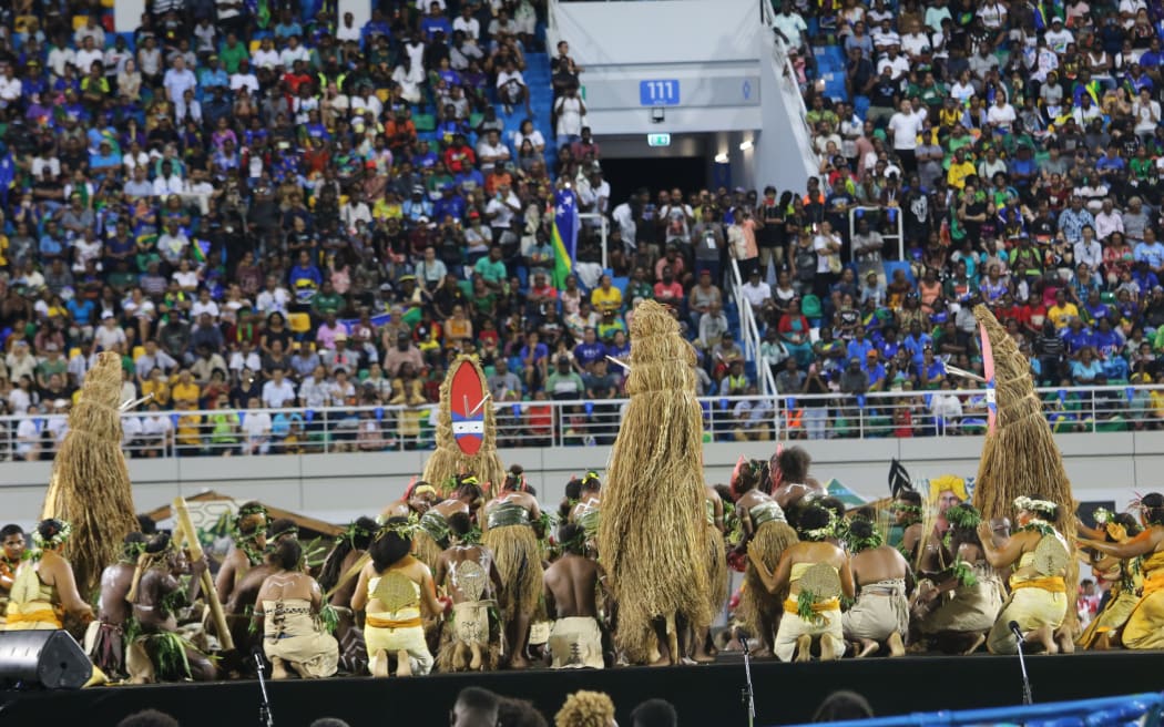 Tamate dance costumes from Vanikoro in Solomon Islands tower above the cultural performers. 19 November 2023.
