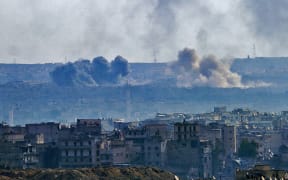 A general view taken from the government-held side of Aleppo shows smoke billowing from the Sheikh Said district during battle between regime forces and rebel fighters on December 3, 2016.