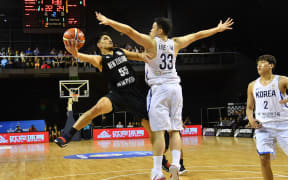 Tall Blacks Shea Ili jumps to shoot with Korea's Seounghyun Lee during the Basketball World Cup qualifier match.