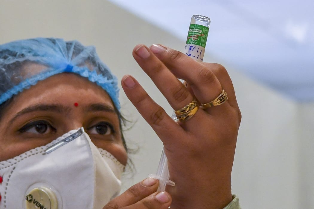 A medical worker prepares to inoculate a colleague with a Covid-19 coronavirus vaccine at a hospital in New Delhi.