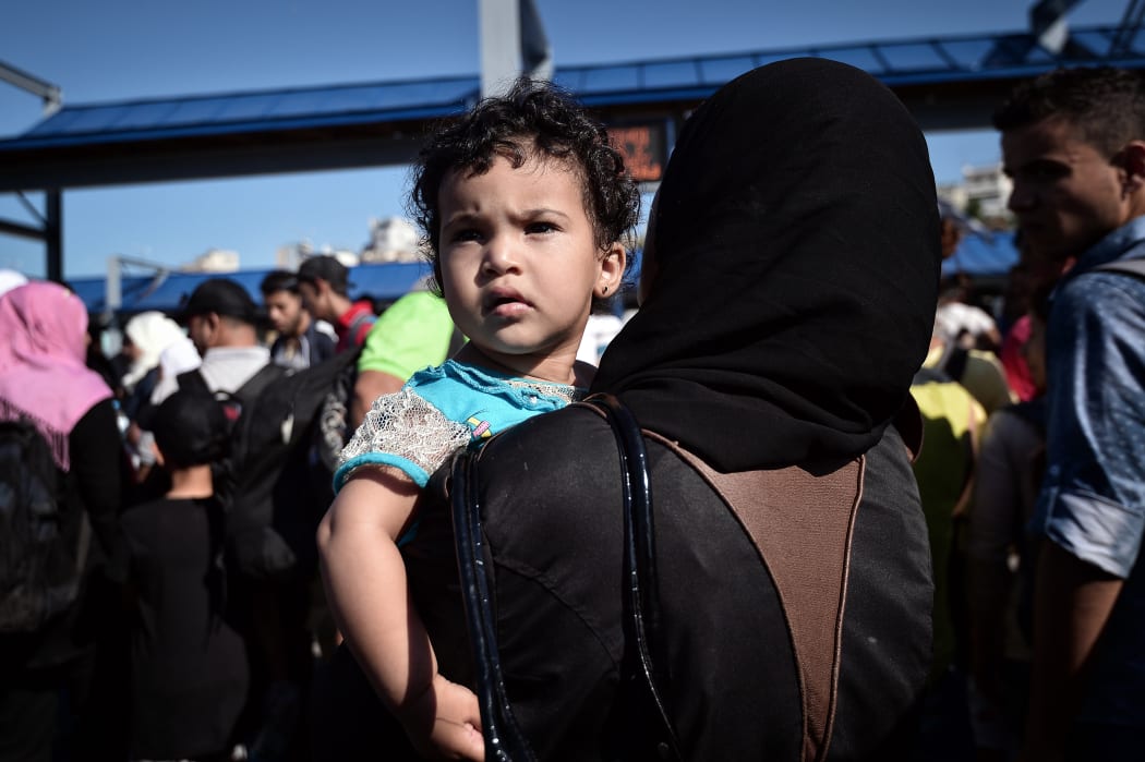 A Syrian child looks on after disembarking from a Greek government-chartered ferry taking refugees from smaller islands, including Leros, to Athens.