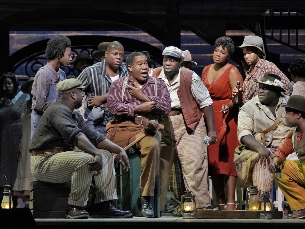 (from left) Ryan Speedo Green (with cap) as Jake, Alfred Walker as Crown, Eric Owens as Porgy, Errin Duane Brooks as Mingo, Angel Blue as Bess, Reginald Smith, Jr. (seated) as Jim, and Chauncey Packer as Robbins