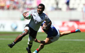 Fiji's Jerry Tuwai breaks through the France defence in Paris.