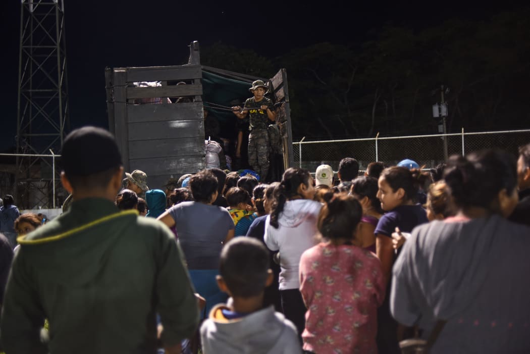 Residents of several communities nearby the erupting Fuego volcano, arrive at a temporary shelter in Escuintl.