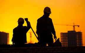 Silhouette of a construction worker.