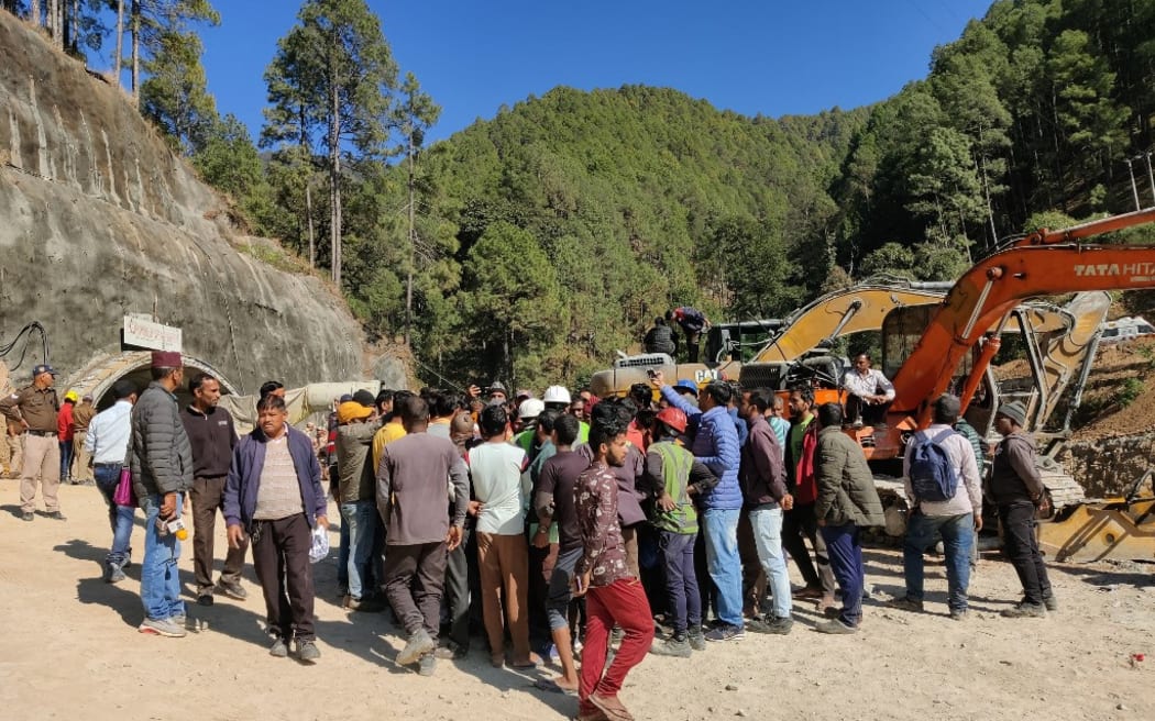 Construction workers protest against authorities for the "slow rescue work" outside the under construction road tunnel that collapsed in Uttarkashi district of India's Uttarakhand state on November 15, 2023.