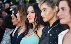 Actress Salma Hayek Pinault, centre,  and Algerian actress Sofia Boutella, second right, walk the red carpet in protest of the lack of female filmmakers honored throughout the history of the Cannes festival.