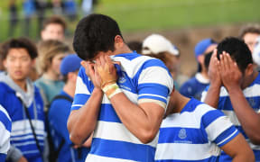 Disappointed St Kentigern's College players bury their heads in their hands after losing to St Peter's in the semi-finals of the Auckland College 1st XV competition.