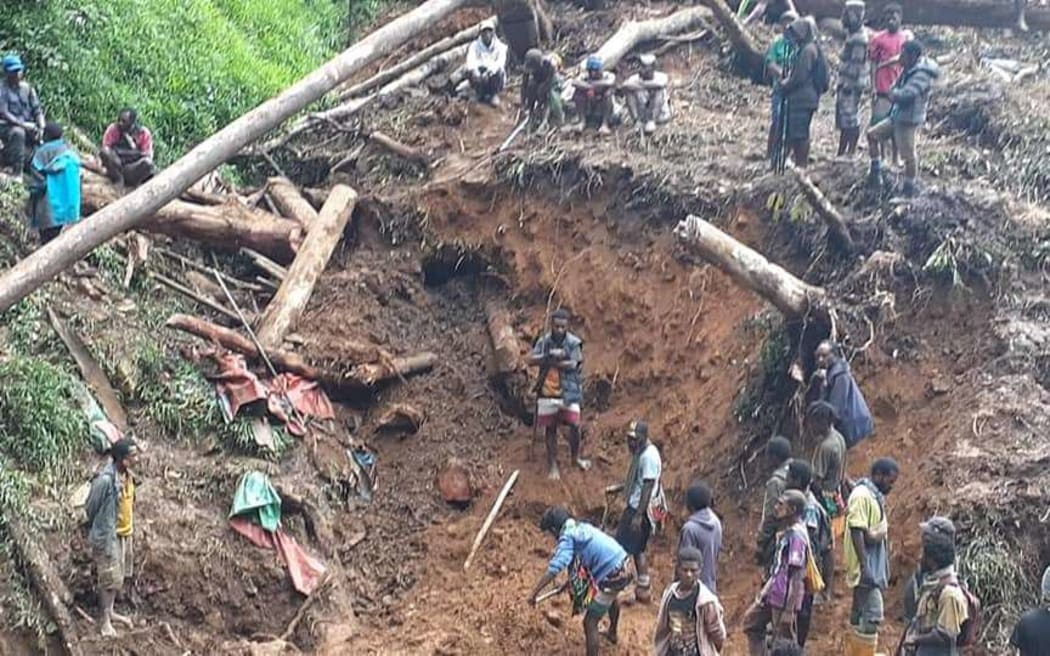 Villagers have been working by hand to recover those buried by a landslide in the Papua New Guinea district of Goilala.