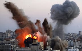 Smoke billows after an Israeli airstrike on Gaza City targeted the Ansar compound, linked to the Hamas movement, in the Gaza Strip on May 14, 2021.