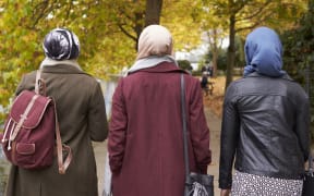 Muslim women walking in urban environment.