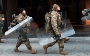 Members of the National Guard walk through the streets as Washington DC remains under tight security during the presidential inauguration