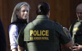 US Department of Homeland Security Secretary Kirstjen Nielsen, left, speaks with Border Patrol agents near a newly fortified border wall structure in Calexico, Calif.