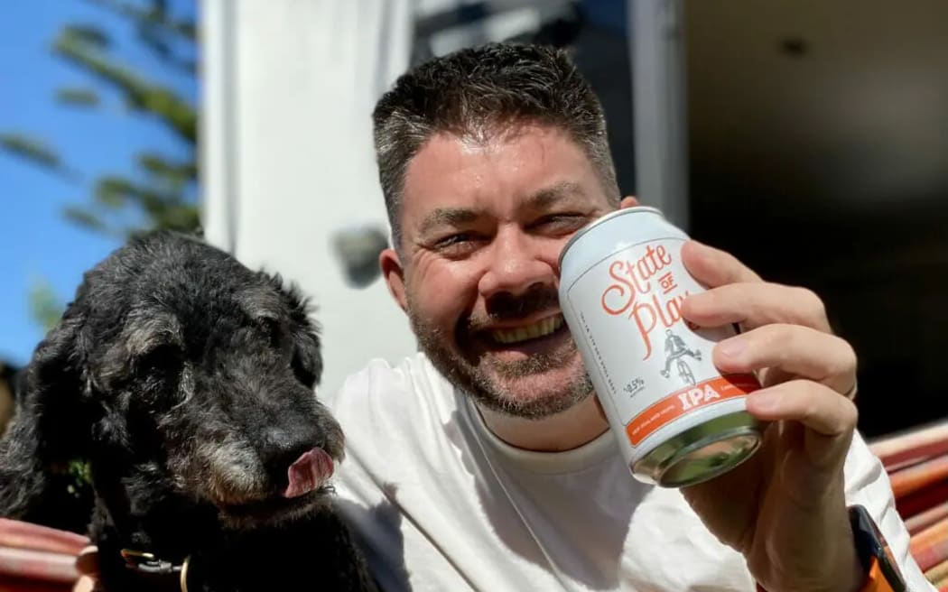 Grant Caunter with a dog and a beer can