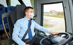 Bus driver wearing face mask - covid-19 coronavirus, public transport, face covering