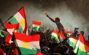 Iraqi Kurds fly Kurdish flags during an event to urge people to vote in the upcoming independence referendum in Arbil, the capital of the autonomous Kurdish region of northern Iraq, on September 15, 2017.