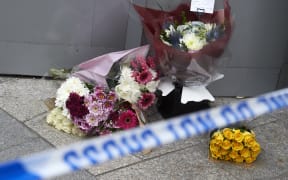 Flowers by the police cordon outside The Shard in London as a tribute to victims.