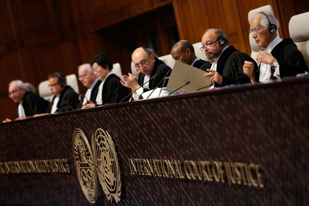 International Court of Justice president Ronny Abraham, second right, examines a document during a court case in December 2015.