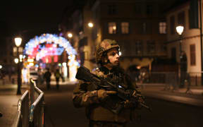 A military stands in the streets of Strasbourg, eastern France, after a shooting breakout.
