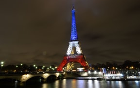 The Eiffel Tower is illuminated with the French national colors in tribute to the victims of the November 13, 2015 Paris terror attacks.