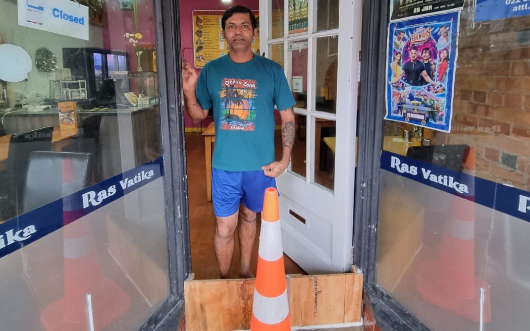 Sajnana Kumar lives above the restaurant Raj Vatika on Dominion Rd in Auckland. The area badly flooded on Friday, prompting him to build a plywood barrier in the shop doorway and concrete up a vent but water still came in this morning.