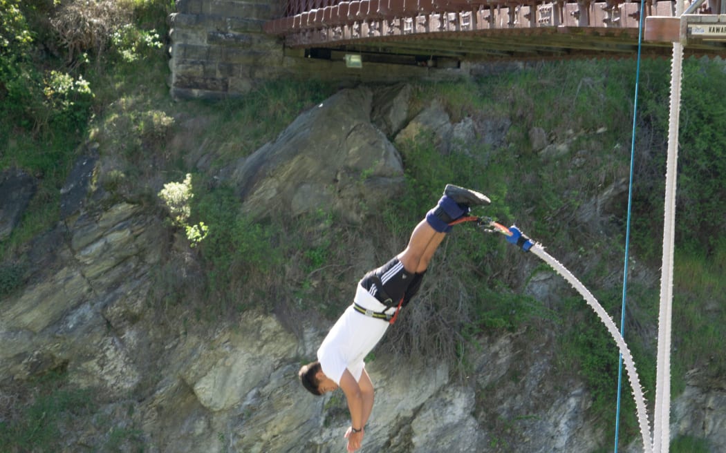 QUEENTSOWN NEW ZEALAND - OCTOBER 21 2018; In motion having leapt off AJ Hacketts Karawau River Bungy  jump facility from bridge across river