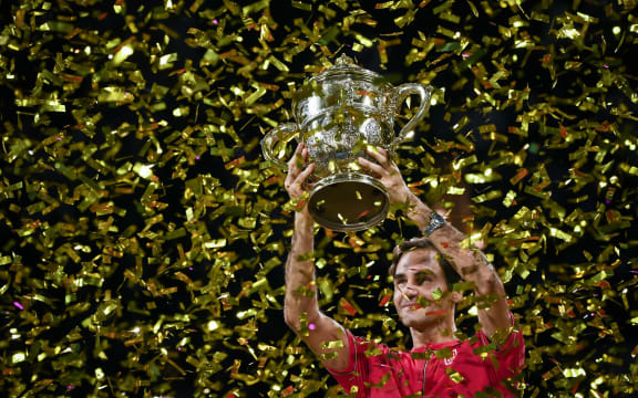 Swiss Roger Federer raises the trophy after his 10th victory at the Swiss Indoors tennis tournament in Basel on October 27, 2019. (Photo by FABRICE COFFRINI / AFP)
