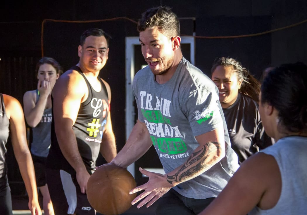 Levi Armstrong has possession while playing basketball with other Patu whanau.