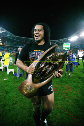 Tony Puletua holds the NRL Trophy after Penrith beat the Roosters 18-6.