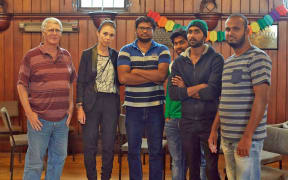 Rahul Reddy (centre) and others were visited at the Unitarian Church by Jacinda Ardern, who promised help.